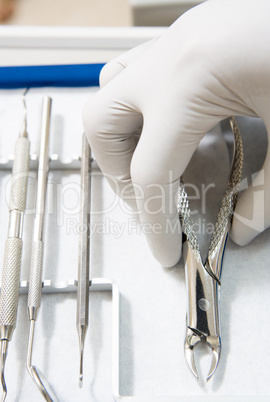 Dental tools with a gloved hand