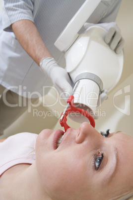 Dentist in exam room with woman in chair