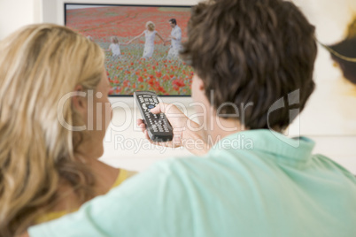 Couple in living room watching television