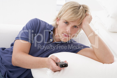 Man in living room holding remote control