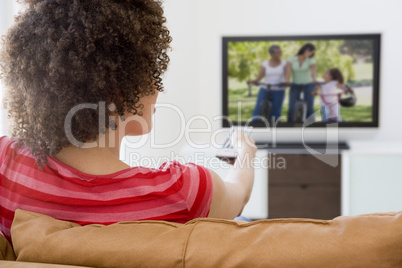 Woman in living room watching television