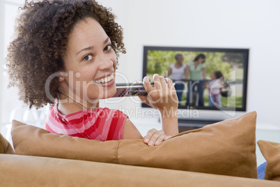 Woman in living room watching television