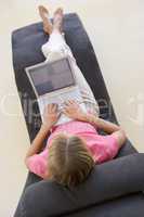 Woman sitting in chair using laptop