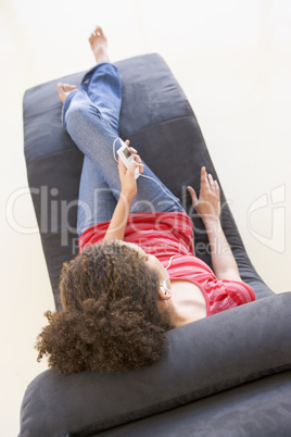 Woman sitting in chair listening to MP3 player