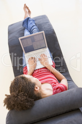 Woman sitting in chair using laptop