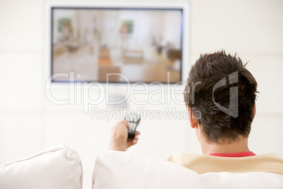 Man in living room watching television