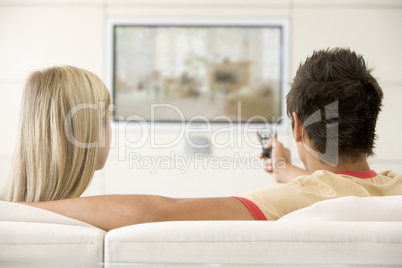 Couple in living room watching television