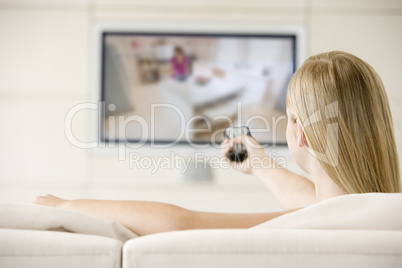 Woman in living room watching television