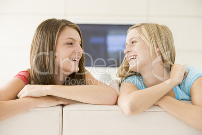 Two women in living room smiling