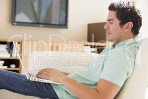 Man in living room using laptop