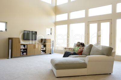 Couple in living room watching television