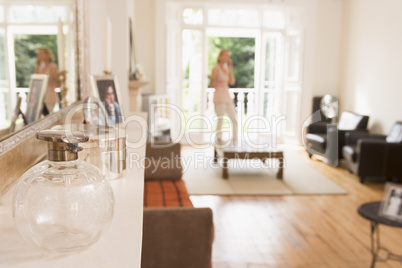 Woman in living room talking on telephone