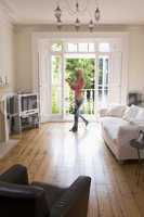 Woman in living room talking on telephone