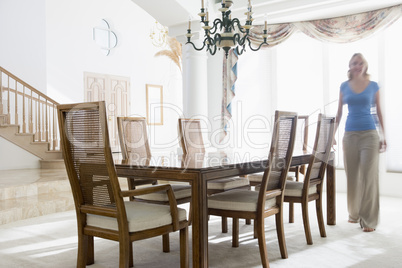 Woman walking in dining room