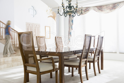 Woman walking by dining room