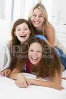 Three women in living room playing and smiling