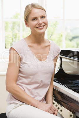 Woman sitting at piano and smiling