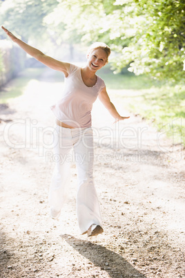 Woman walking on path smiling