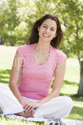 Woman sitting outdoors smiling