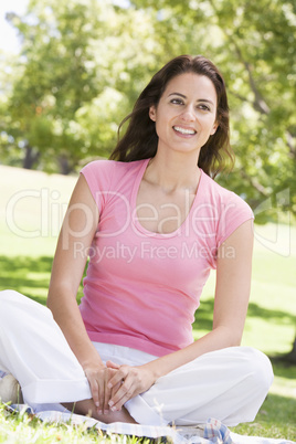 Woman sitting outdoors smiling