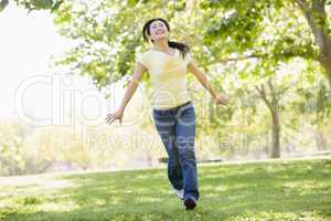Woman running outdoors smiling