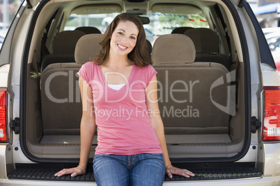 Woman sitting in back of van smiling