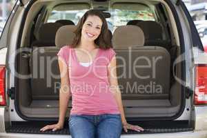 Woman sitting in back of van smiling