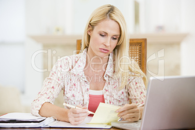 Woman in dining room with laptop