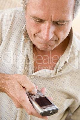 Man using cellular phone indoors