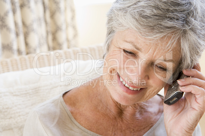 Woman indoors using cellular phone