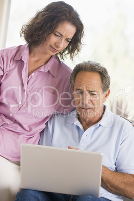 Couple in living room with laptop
