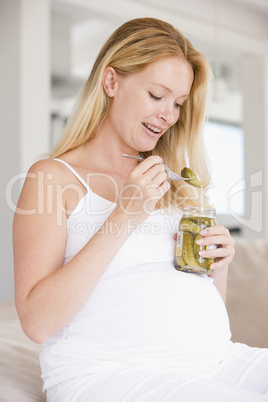 Pregnant woman with pickles smiling