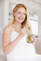 Pregnant woman with pickles smiling