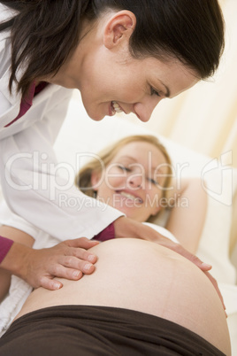 Pregnant woman getting check up from doctor