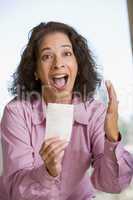 Woman with winning lottery ticket excited and smiling