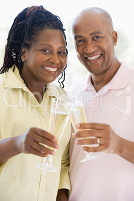 Couple toasting champagne and smiling