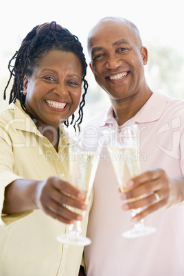 Couple toasting champagne and smiling