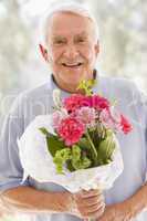 Man holding flowers and smiling