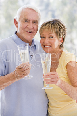 Couple toasting champagne and smiling