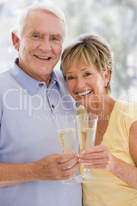 Couple toasting champagne and smiling