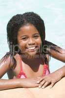 Young girl in swimming pool smiling
