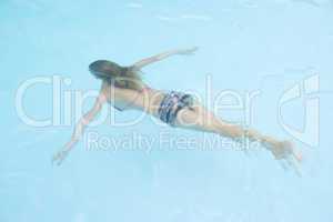 Young girl in swimming pool underwater