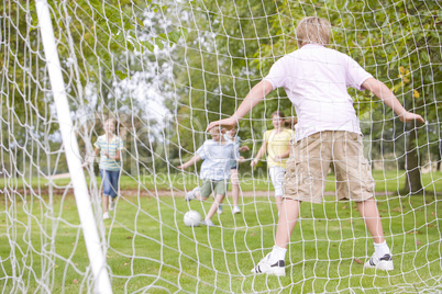 Five young friends playing soccer