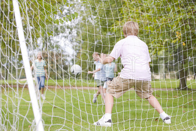 Five young friends playing soccer