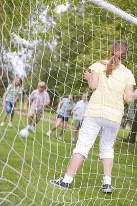 Five young friends playing soccer