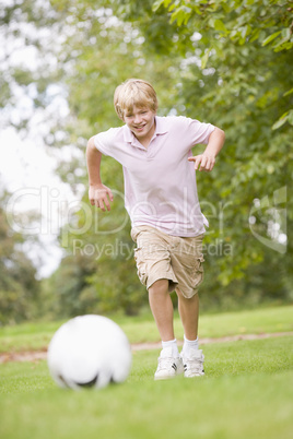 Young boy playing soccer