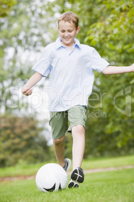 Young boy playing soccer