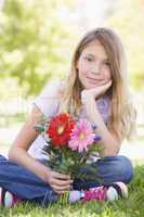 Young girl holding flowers and smiling