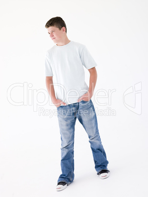 Teenage boy standing with hands in pockets