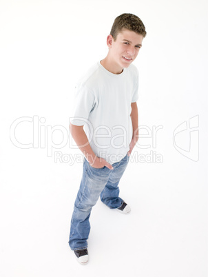 Teenage boy standing with hands in pockets